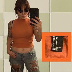 Orange mock turtleneck crop top.